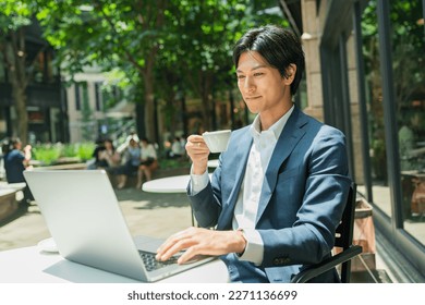 Young Asian businessman working in the business district - Powered by Shutterstock