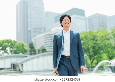 Young Asian businessman working in the business district - Powered by Shutterstock