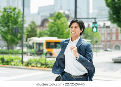 Young Asian businessman working in the business district - Powered by Shutterstock