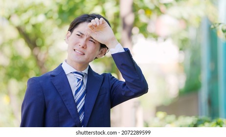 Young Asian Businessmen Working Outside