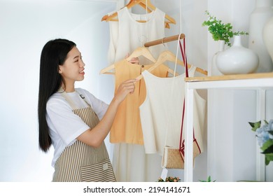 Young Asian Businessowner Checking Clothes In Small Business.Businessman Checking Inventory In Stock Room. Store House Inspection.