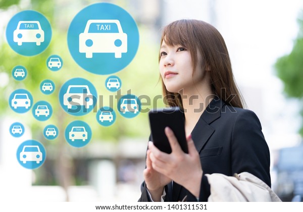 young asian\
businesswoman calling\
taxi