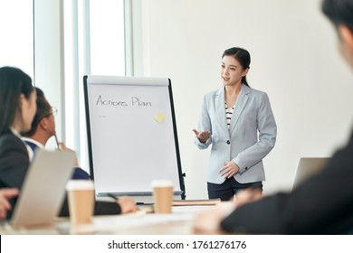 Young Asian Businesswoman Facilitating A Discussion During Team Meeting In Office