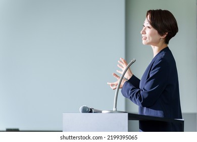 young asian businesswoman giving a presentation in a conference room - Powered by Shutterstock