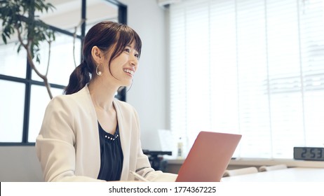 Young Asian Businesswoman Talking In The Office.