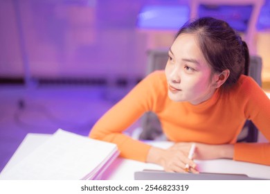 Young asian businesswoman is thinking and working at home office desk at night with laptop computer, paperwork and digital tablet - Powered by Shutterstock