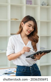 Young Asian Businesswoman Using Tablet With Smiling Face, Positive Emotion, At Office, Casual Office Life Concept