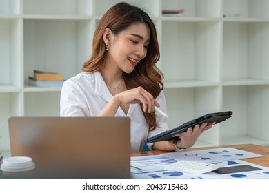 Young Asian Businesswoman Using Tablet With Smiling Face, Positive Emotion, At Office, Casual Office Life Concept