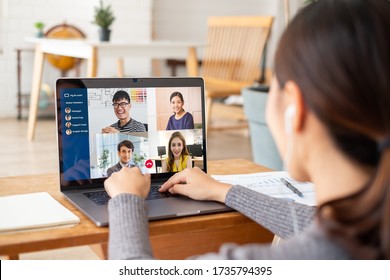 Young Asian Businesswoman Work At Home And Virtual Video Conference Meeting With Colleagues Business People, Online Working, Video Call Due To Social Distancing At Home Office