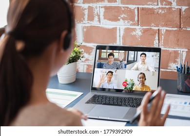 Young Asian Businesswoman Work At Home And Virtual Video Conference Meeting With Colleagues Business People, Online Working, Video Call Due To Social Distancing At Home Office