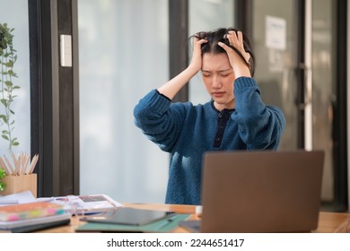 Young Asian businesswomen with office syndrome have a problem with feeling headaches and stress back healthy problems after working on a laptop for a long time. Healthcare, Office syndrome concept - Shutterstock ID 2244651417