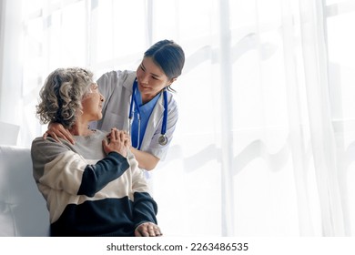 Young asian caretaker with 60s asia elderly woman consulting and encourage, take a history and recommend the right treatment, holding hands and encouraging - Shutterstock ID 2263486535