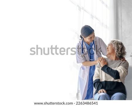 Young asian caretaker with 60s asia elderly woman consulting and encourage, take a history and recommend the right treatment, holding hands and encouraging
