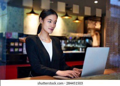 Young Asian Chinese Business Woman Using Cafe Wifi Connection For Laptop Computer Work