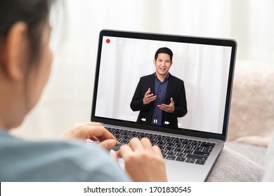Young asian chinese leader or businessman on management forum, teleconference, town hall or press video conference online with work remotely at home during coronavirus and business continuity concept.