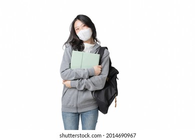 Young Asian College Student Wears Face Mask And Hoodie Sweatshirt With Laptop And Backpack Isolated Over White Background