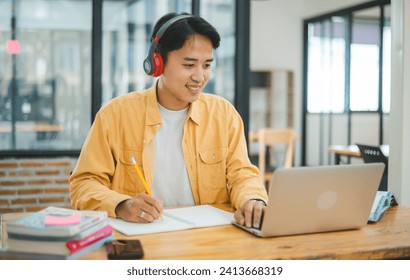 Young Asian college student working and learning on laptop In the cafe. Searching for knowledge online. - Powered by Shutterstock