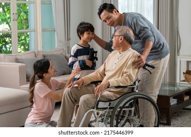 Young Asian Couple And Child Visiting Grandparents In Nursing Home