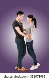 Young Asian Couple Dancing With Smiling Face.