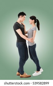 Young Asian Couple Dancing With Smiling Face.