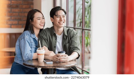 Young Asian couple dating at coffee shop - Powered by Shutterstock