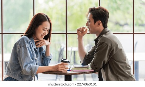 Young Asian couple dating at coffee shop - Shutterstock ID 2274063101