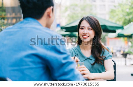 Young Asian couple dating at coffee shop