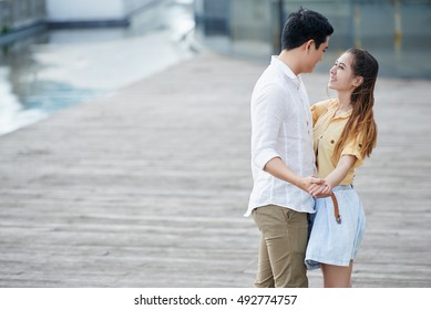 Young Asian Couple In Love Dancing Outdoors