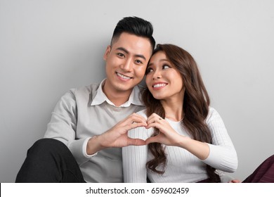 Young Asian Couple Make Heart Symbol From Their Hands