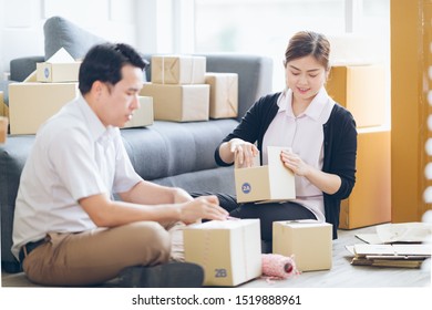 Young Asian Couple Move Cardboard Parcel At New Home,packing Cardboard Box