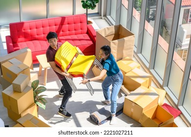 Young Asian Couple Move Into New Apartment On Moving Day, Celebrating Moving To New Home Concept