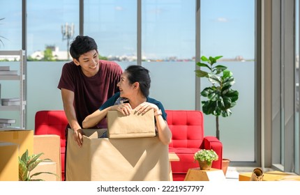 Young Asian Couple Move Into New Apartment On Moving Day, Celebrating Moving To New Home Concept