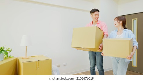 Young Asian Couple Moving Into New Home - They Carry Many Boxes