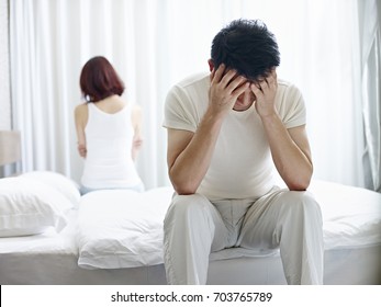 Young Asian Couple With Relationship Problem Appear Depressed And Frustrated.