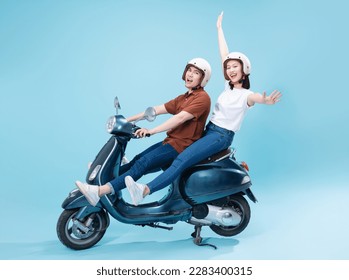Young Asian couple ride scooter on background - Shutterstock ID 2283400315