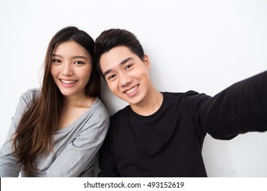 Young Asian Couple Taking Selfie