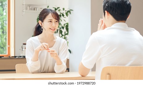 Young asian couple talking in the room. - Powered by Shutterstock