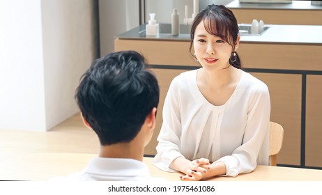 Young asian couple talking in the room. - Powered by Shutterstock