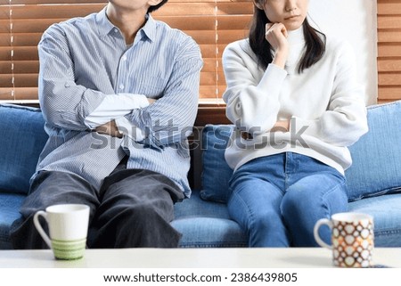 Young Asian couple thinking (fighting) while sitting on the sofa
 Stock photo © 