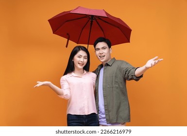 Young Asian couple with umbrella on background - Powered by Shutterstock