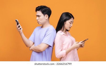 Young Asian couple using smartphone on background - Powered by Shutterstock