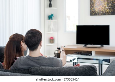 Young Asian couple watching movie on tv at home.Enjoy watch movie at home
