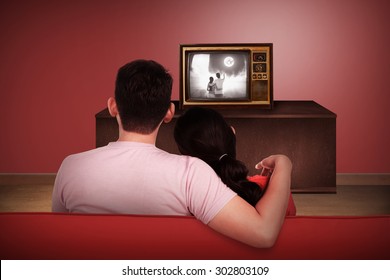 Young Asian Couple Watching Retro Tv In The House