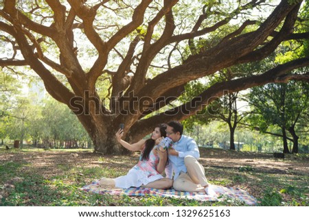 Young Asian couples in the garden, watching the garden smiling like good
The concept of lovers and romance