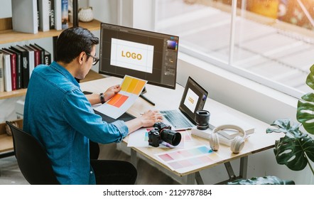 Young Asian designer working at office - Powered by Shutterstock