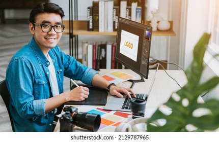 Young Asian designer working at office - Powered by Shutterstock