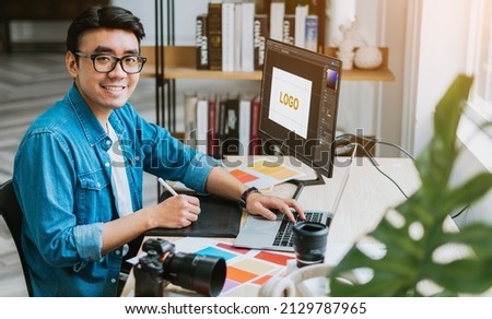 Young Asian designer working at office