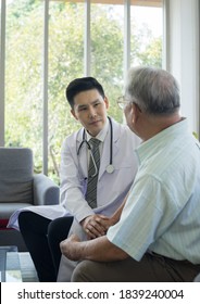 Young Asian Doctor Is Discussing And Consulting Senior Man In Home. Concept Senior Meet A Doctor, Medical Checkup, Medical Consultation