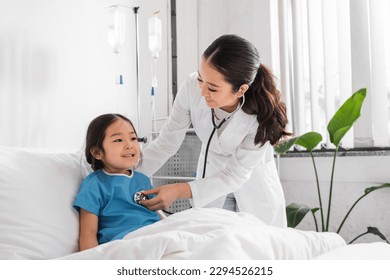 young asian doctor with stethoscope examining joyful girl in pediatric hospital - Powered by Shutterstock