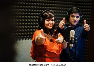 Young Asian Duet Singers With Microphone Recording Song In Record Music Studio.